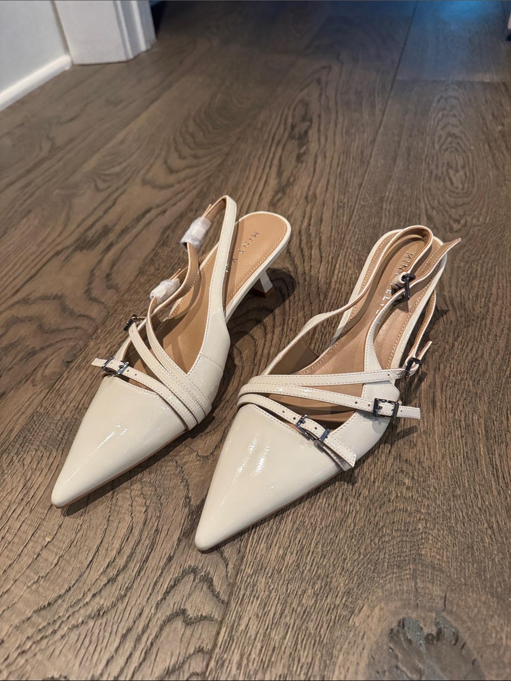 Patent Pointed-Toe Slingback Heels in Cream
